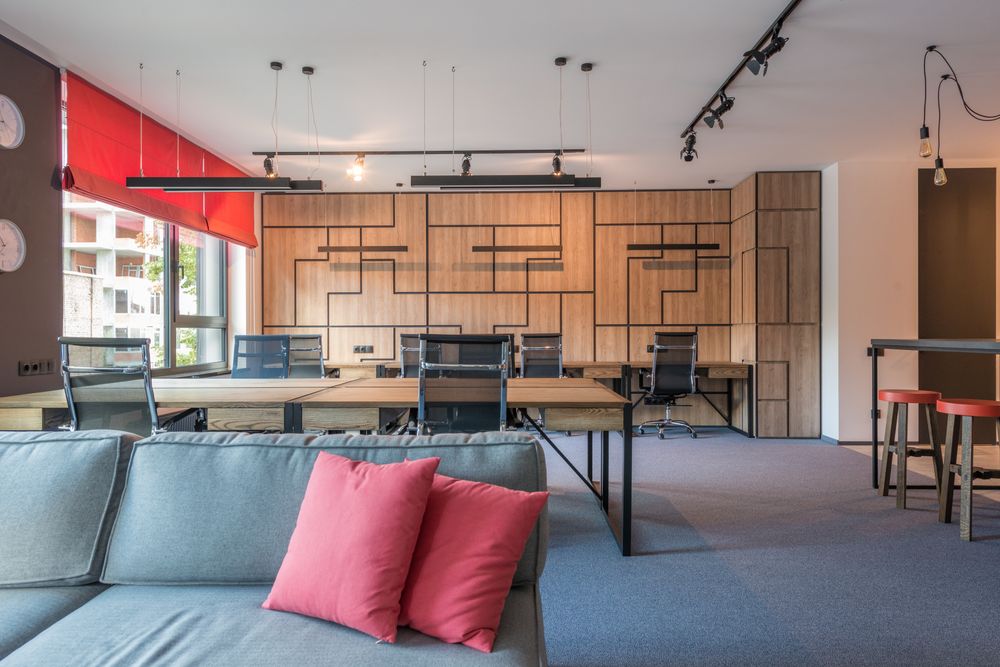 Modern office with suspended linear lights and ceiling spotlights